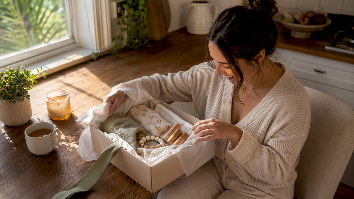 Mother opening baby shower gift at home