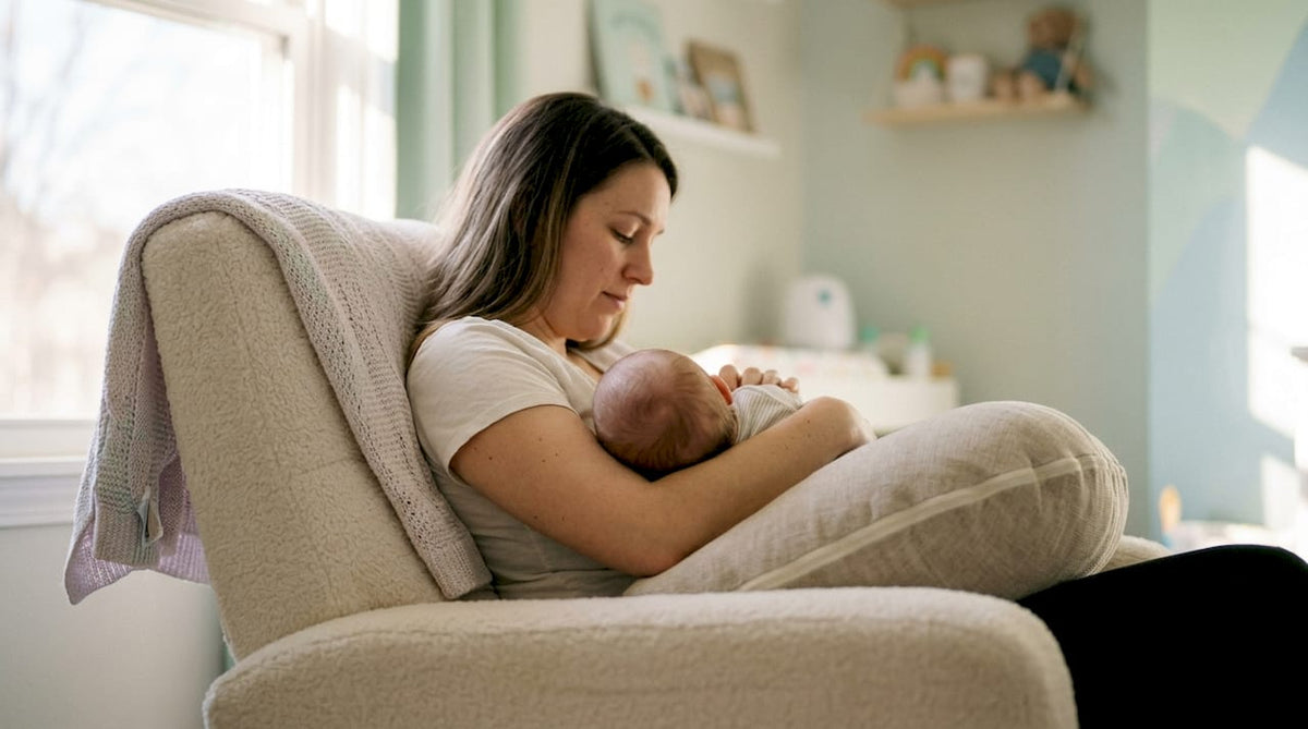 Mother feeding baby comfortably with nursing pillow in recliner
