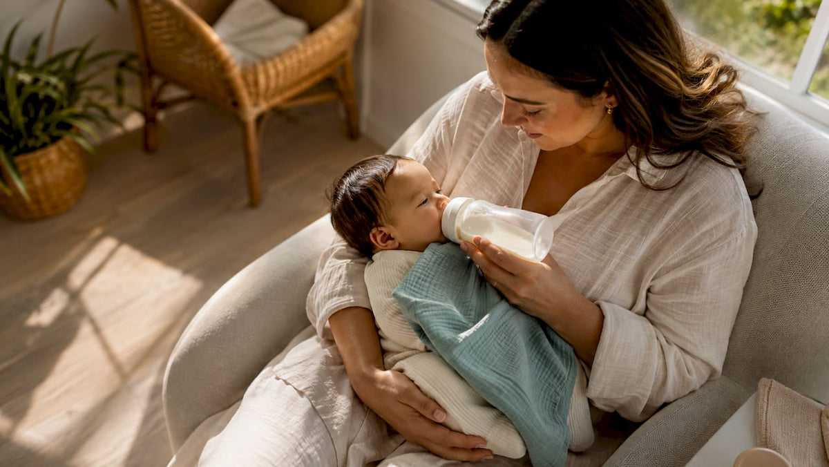 Mother bottle feeding baby in supported position